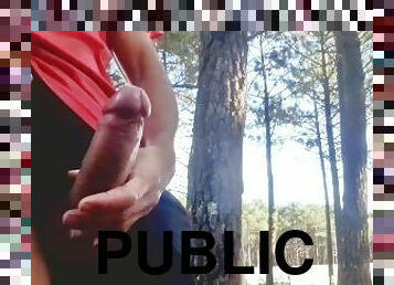 Sexy guy jacking off in public near the road.