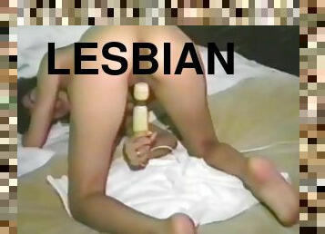 Lesbian girls from the 90's toy their pussies with a black dildo