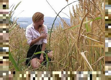 Out in a field of wheat she pulls her panties aside and fingers