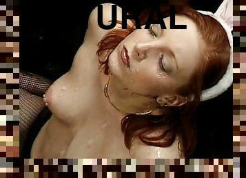 Seductive redhead gets her face covered in jizz at a raunchy bukkake party