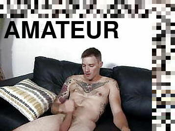 Military inked stud wanking his cock on couch