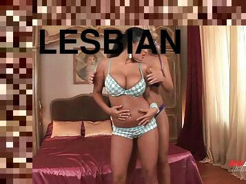 Hot lesbians caress their massive melons against each other in a steamy girl to girl romance