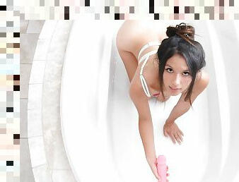 Brunette Melody enjoys while fingering her pussy in the bathtub
