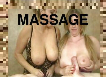 Man on massage table gets handjob from two babes