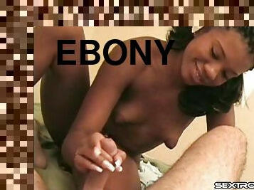 Thong-clad ebony-skinned slut with small tits playing with a white cock