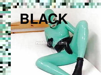 Jade and black rubber doll in total latex enclosure