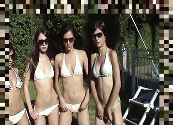 Four gorgeous teens having a bikini party in the back yard