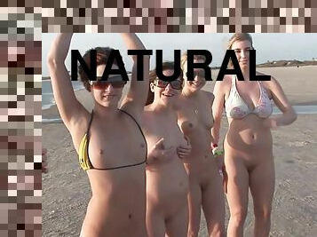 Models with natural tits,in bikini flash their bodies on the beach outdor
