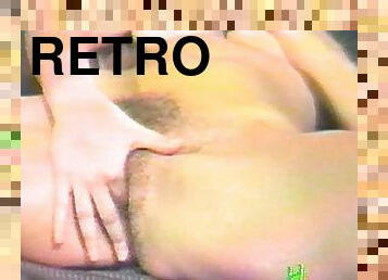 A retro home video of a hairy amateur massaging her pussy