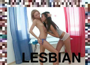 Sensual lesbian teens with long hair caressing their bodies before fingering passionately