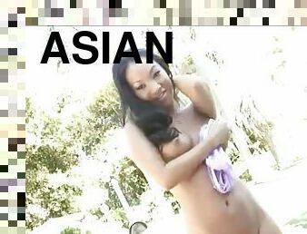 Sexy Asian pornstar stroking her wet tunnel with a dildo outdoors
