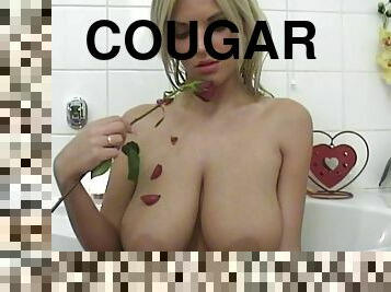Blonde cougar with huge natural tits touching her sexy body