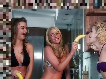 Kimberly, Samantha and Sophia play with a banana in the kitchen