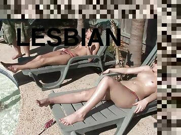 A few lesbians rub each other's tits on the poolside in reality clip