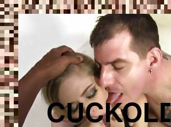 A cuckolded guy sucks a dildo while his wife gets fucked