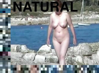 Naturally busty amateur milf gets caught on a cam on nude beach