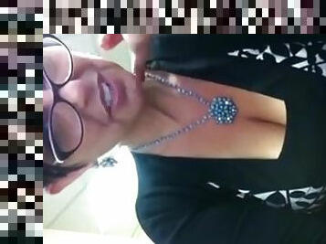 Brunette milf in glasses shows her sexy cleavage for the webcam