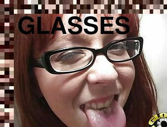 A redhead girl in glasses blows a big black cock in a toilet