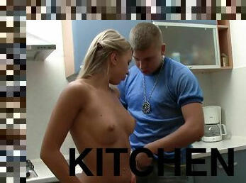 A delightful teen gets fucked from behind in a kitchen