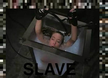Slender blond is tied up and put in the immersion tank