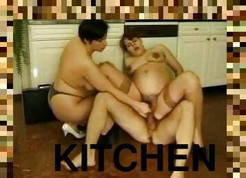 Very pregnant brunette gets fucked in a FFM threesome in the kitchen