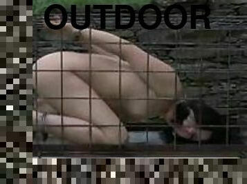 Outdoor BDSM for Enema locked in a tiny cage