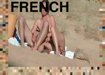 Lewd French couple touch each other's privates on a beach