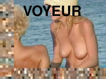 Pretty girls get their pussies filmed with a voyeur's cam on a nude beach