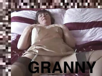 Slutty granny plays with a dildo and shows off her hairy cunt
