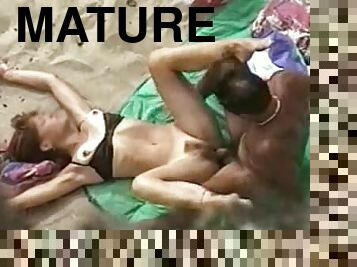 Mature slut gets her hairy pussy banged on a beach