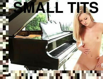 Lovely Jessie Rogers fondles her pussy near the piano