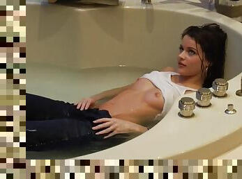 Mya Matthews lies in a bathtub showing her slim body