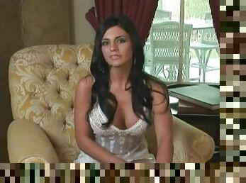 Sexy Vanessa Raia sits in an armchair and gives an interivew