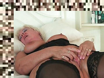 Curvy granny in black stockings rubs her old clit
