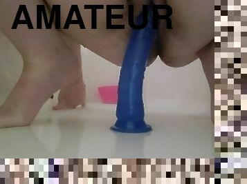 Riding a blue dildo in shower