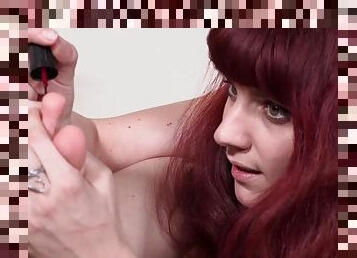 Barefoot redhead babe Lauretta applying nail polish