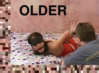 Hardcore fucking on the bed between an older guy and his female slave