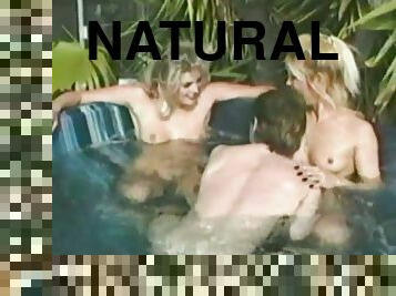 Two blondes have a threesome sex in an inflatable pool