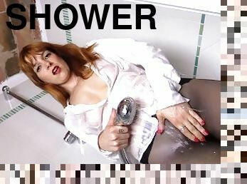 After taking off her skirt, tee shirt and also heels, redhead Irina Vega takes a shower while still