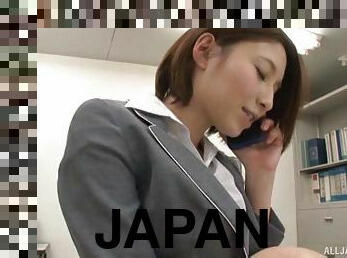 Astonishing Japanese brunette gives a stunning handjob in the office