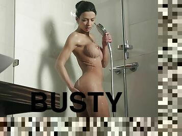 Hot busty babe washes her naked body in shower