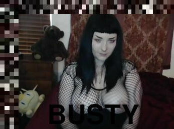 Busty brunette in fishnet outfit teasing on webcam solo