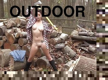 Lumberjill - Daisy Haze chopping wood with an ax naked outdoors