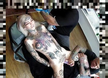 Sascha plays with Amber Luke while she gets tattooed