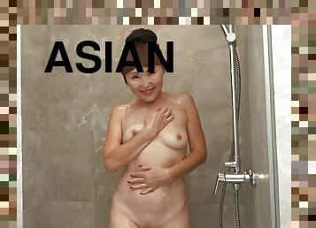 Saggy tit asian granny takes a hot shower and fucking her old tight cunt with a black dildo