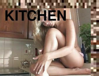 Lovely babe Mischa loves playing with her pussy in the kitchen