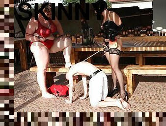 Kinky sluts enjoy torturing their skinny male slave in outdoors