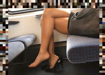Lady with sexy legs in heels on the train