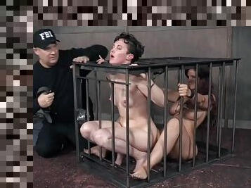 Girls in a cage together submit to BDSM pain