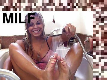 During her bath, this astonishing blonde MILF loves to lick her sexy feet